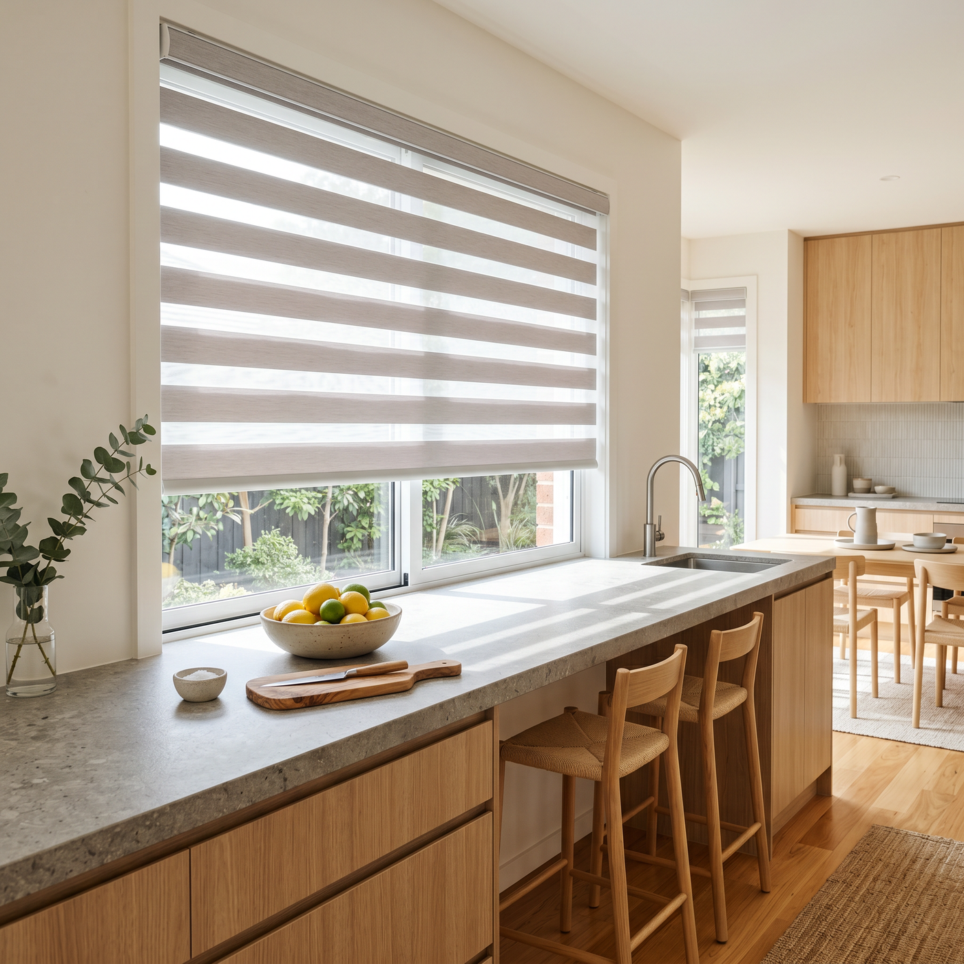 Strata Zebra Blind with sheer and opaque bands filtering soft daylight over a wide modern Australian kitchen window.